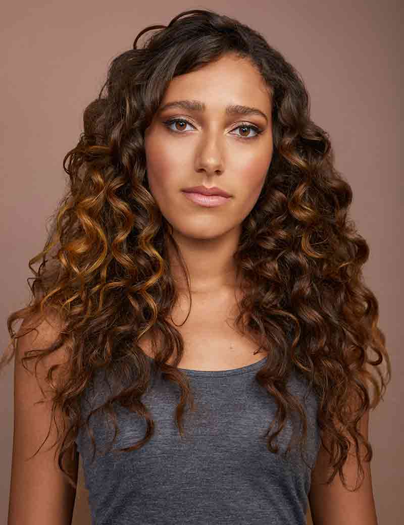Woman with long, curly brown hair
