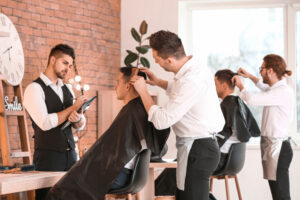 Young man cutting a man's hair for an exam