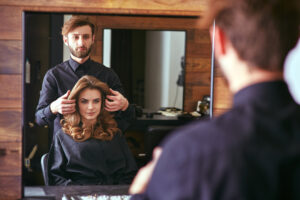 Woman getting haircut at the beauty salon from hairdresser