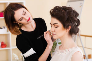 Makeup artist applying makeup to the model